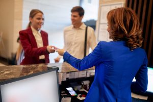 Business couple checking in at hotel reception